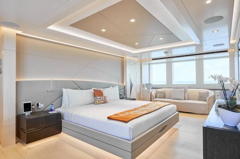 a large white bed in a room aboard ARKADIA Yacht for Charter