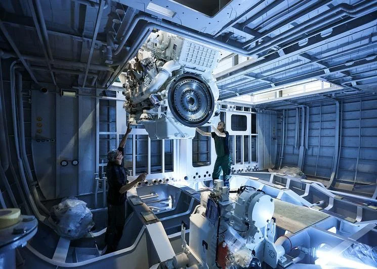 a few people in a factory aboard ARKADIA Yacht for Charter