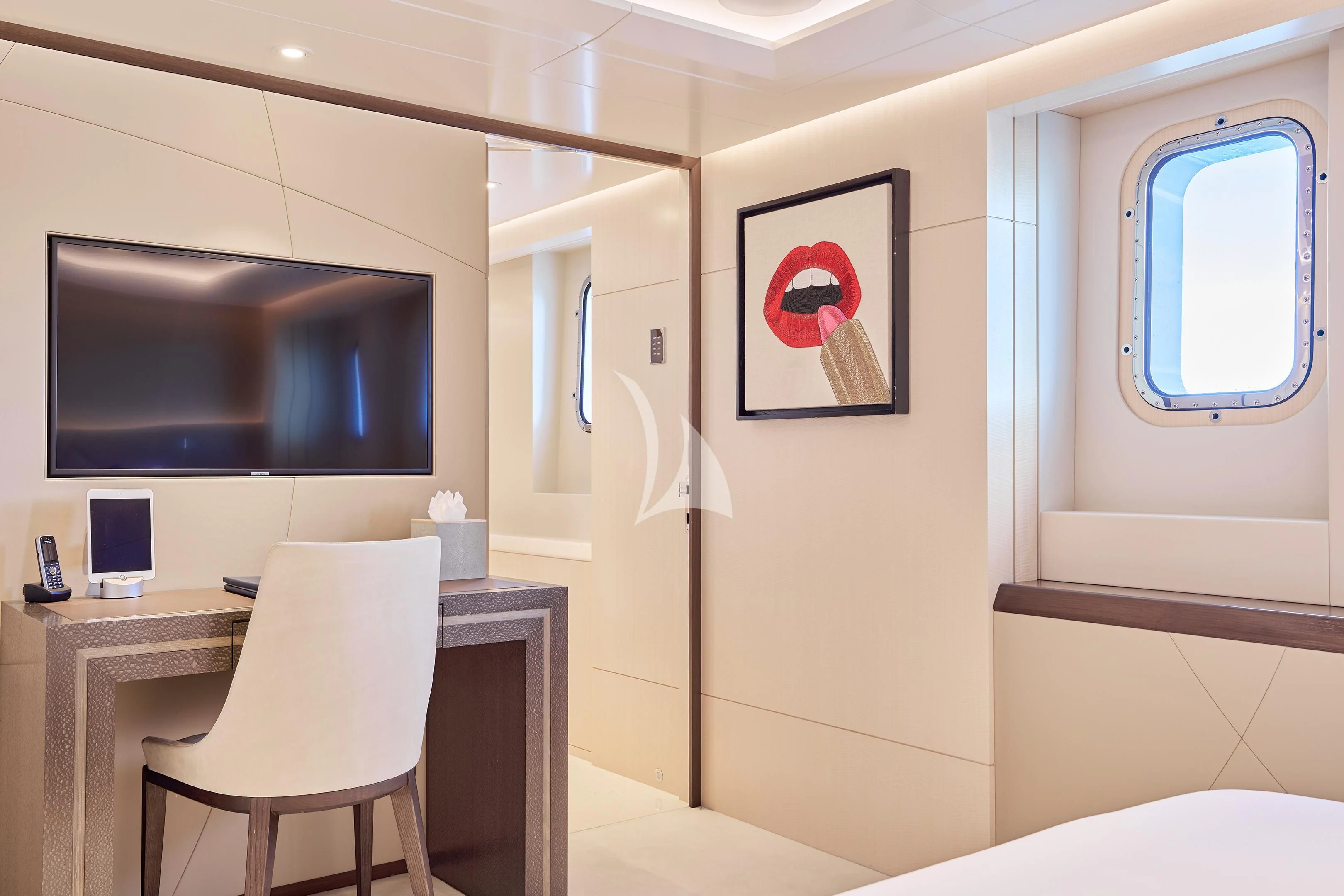 a room with a desk and tv aboard ARKADIA Yacht for Charter
