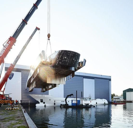 a large crane lifting a container aboard ARKADIA Yacht for Charter