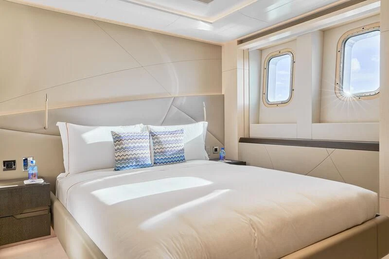 a bed with white sheets and pillows aboard ARKADIA Yacht for Charter