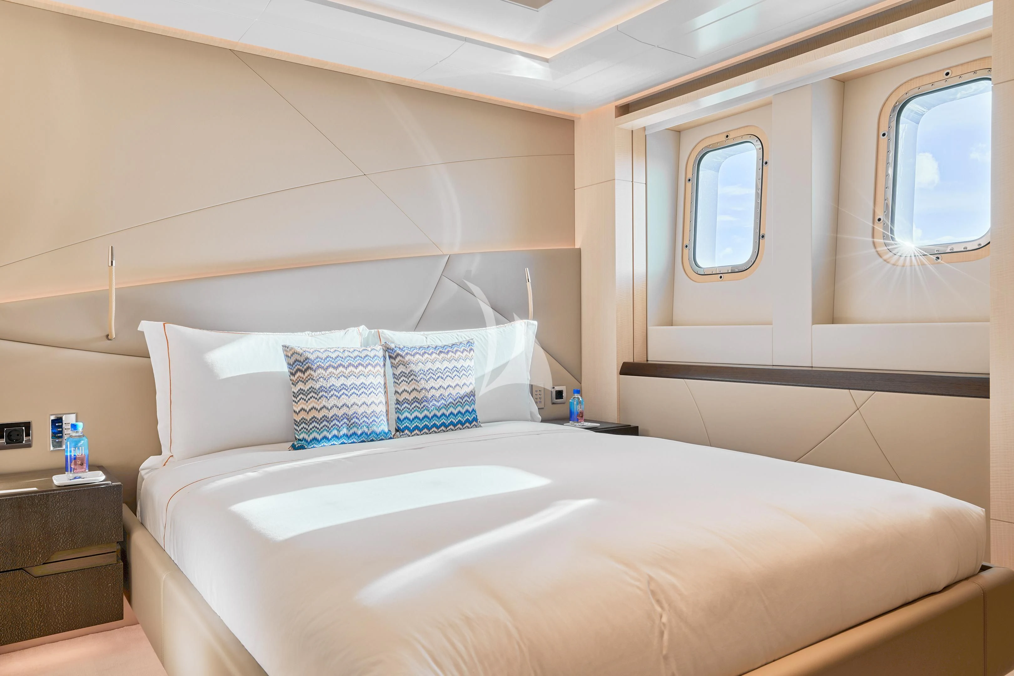 a bed with white sheets and pillows aboard ARKADIA Yacht for Charter