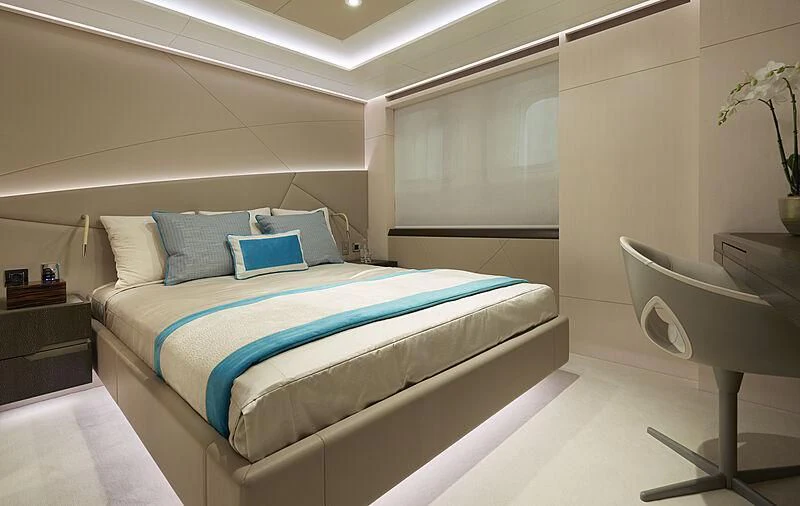 a bed with blue sheets aboard ARKADIA Yacht for Charter