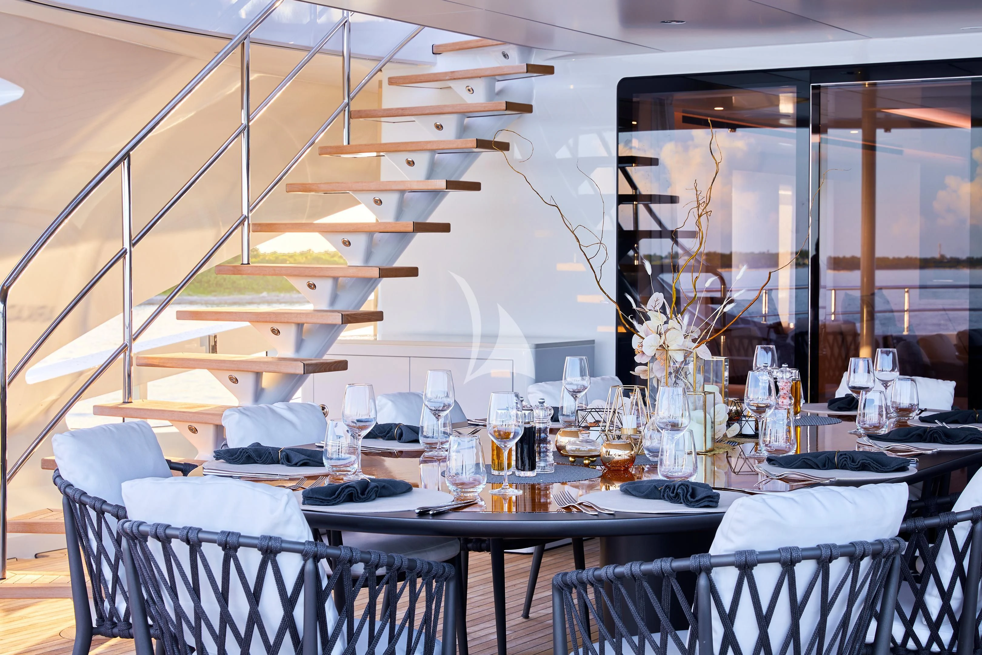 a dining room with a set of tables and chairs aboard ARKADIA Yacht for Charter
