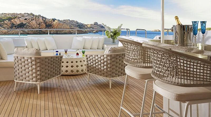 a table and chairs on a deck aboard ARKADIA Yacht for Charter