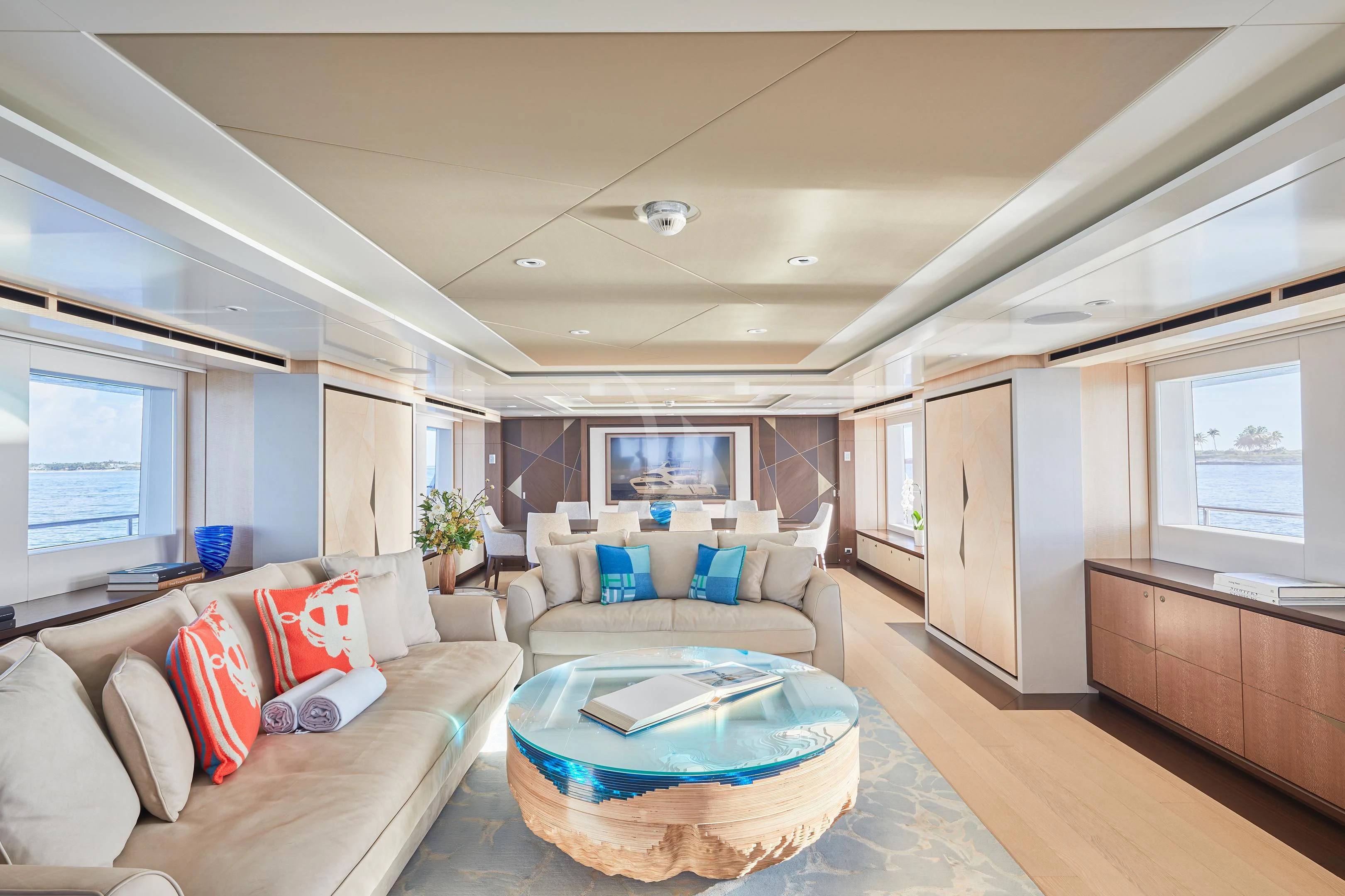 a living room with a large blue round table and a blue couch aboard ARKADIA Yacht for Charter
