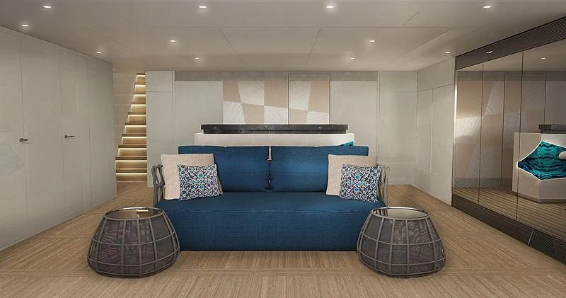 a large blue couch in a room aboard ARKADIA Yacht for Charter