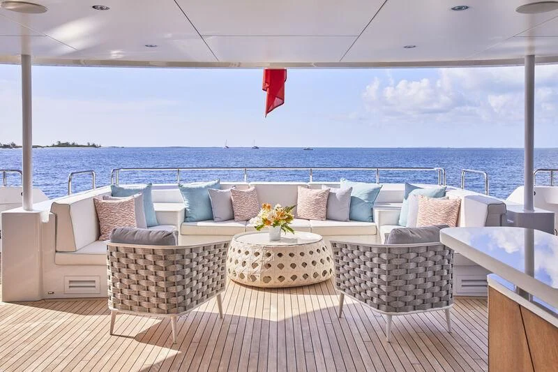 a large white patio with a large body of water in the background aboard ARKADIA Yacht for Charter