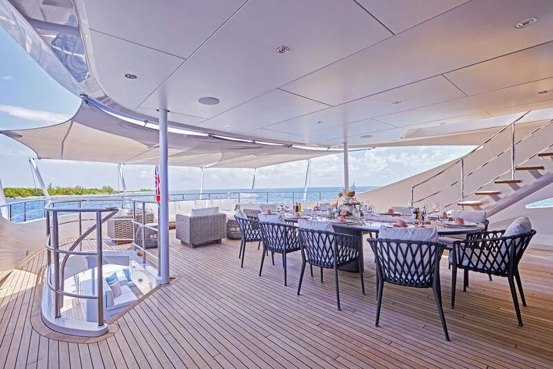 a room with a table and chairs aboard ARKADIA Yacht for Charter
