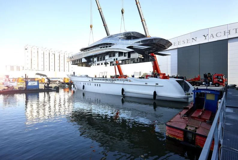 a large white boat docked at a dock aboard ARKADIA Yacht for Charter
