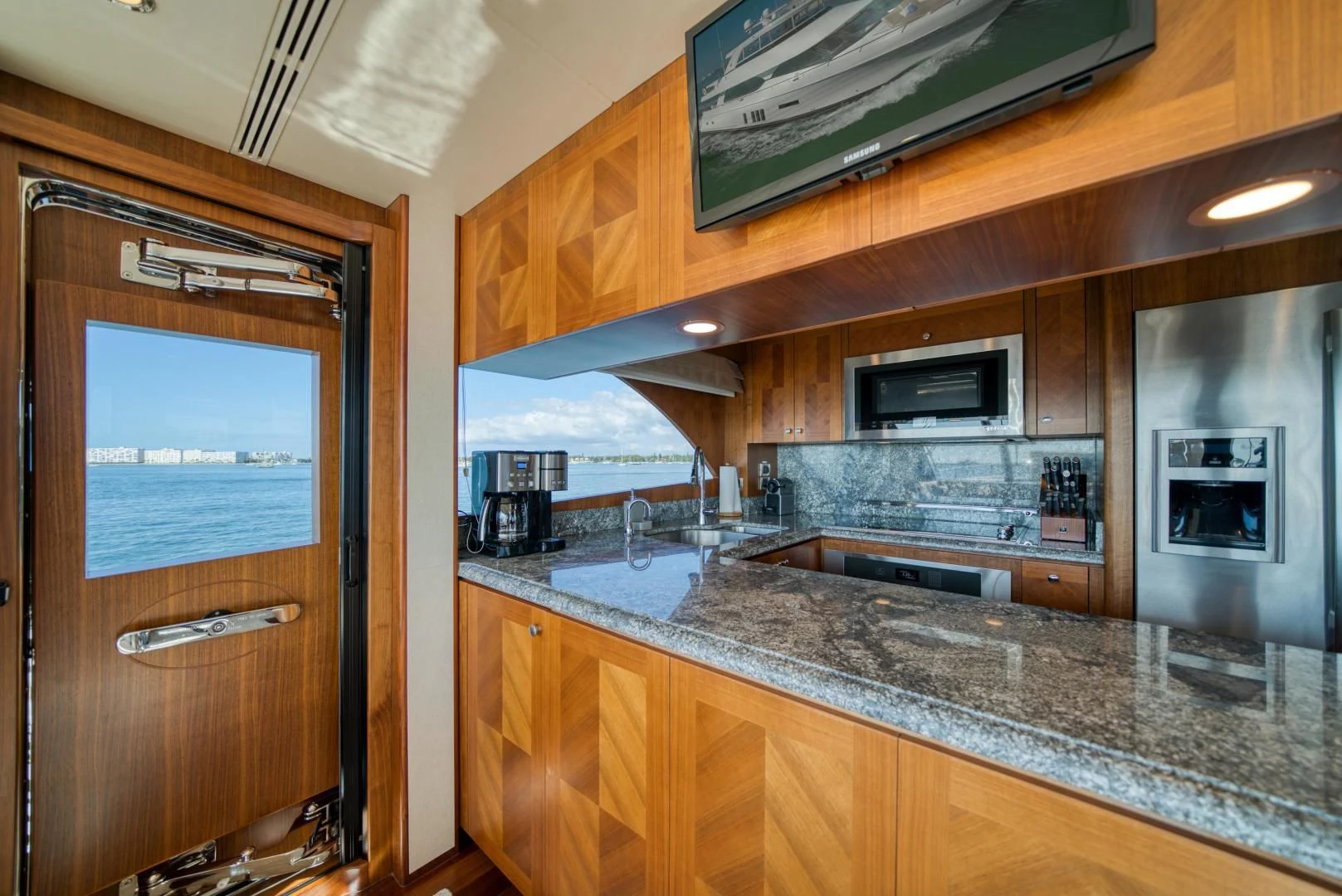 a kitchen with wooden cabinets aboard SANCTUARY Yacht for Sale