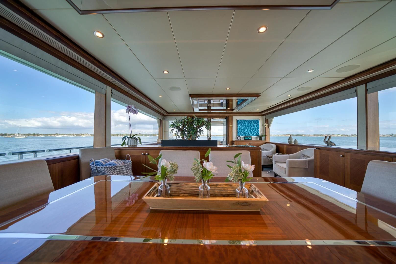 a room with a wood floor and a large window with a view of the water aboard SANCTUARY Yacht for Sale
