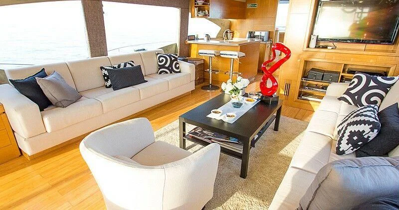 a living room with a couch and a coffee table aboard DURETTI 85 Yacht for Sale