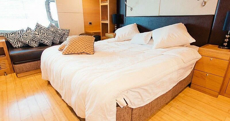 a bed with white sheets aboard DURETTI 85 Yacht for Sale