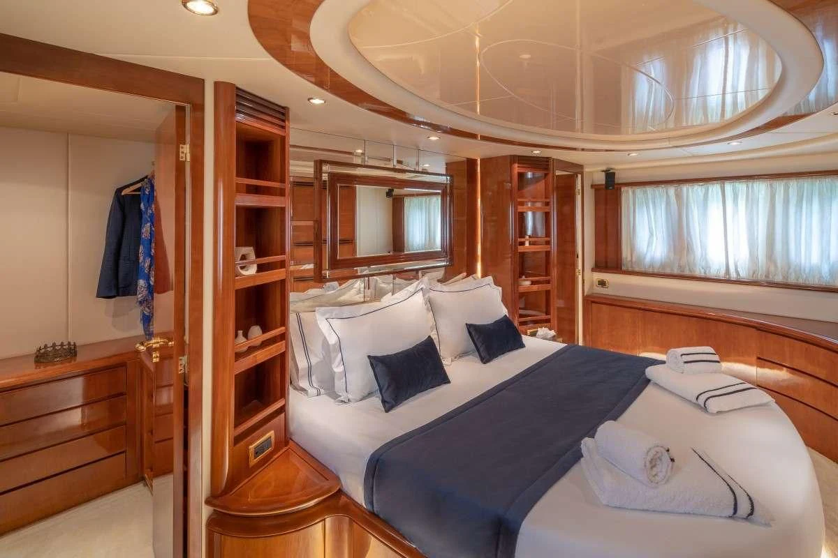 a bedroom with a closet and a bed aboard ESTIA ZEUS Yacht for Charter