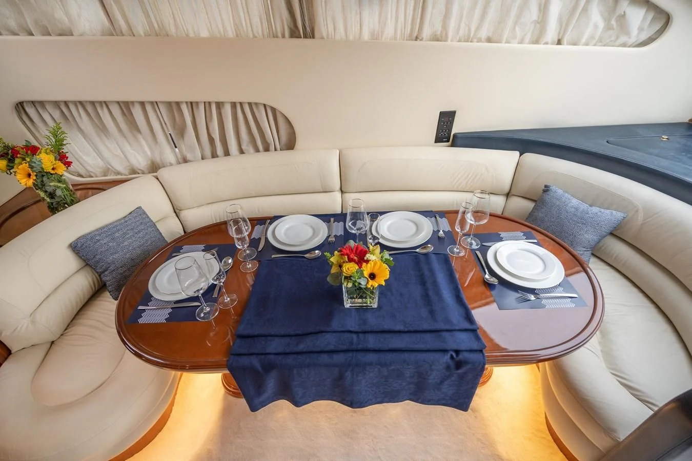a table with plates and glasses on it aboard ESTIA ZEUS Yacht for Charter