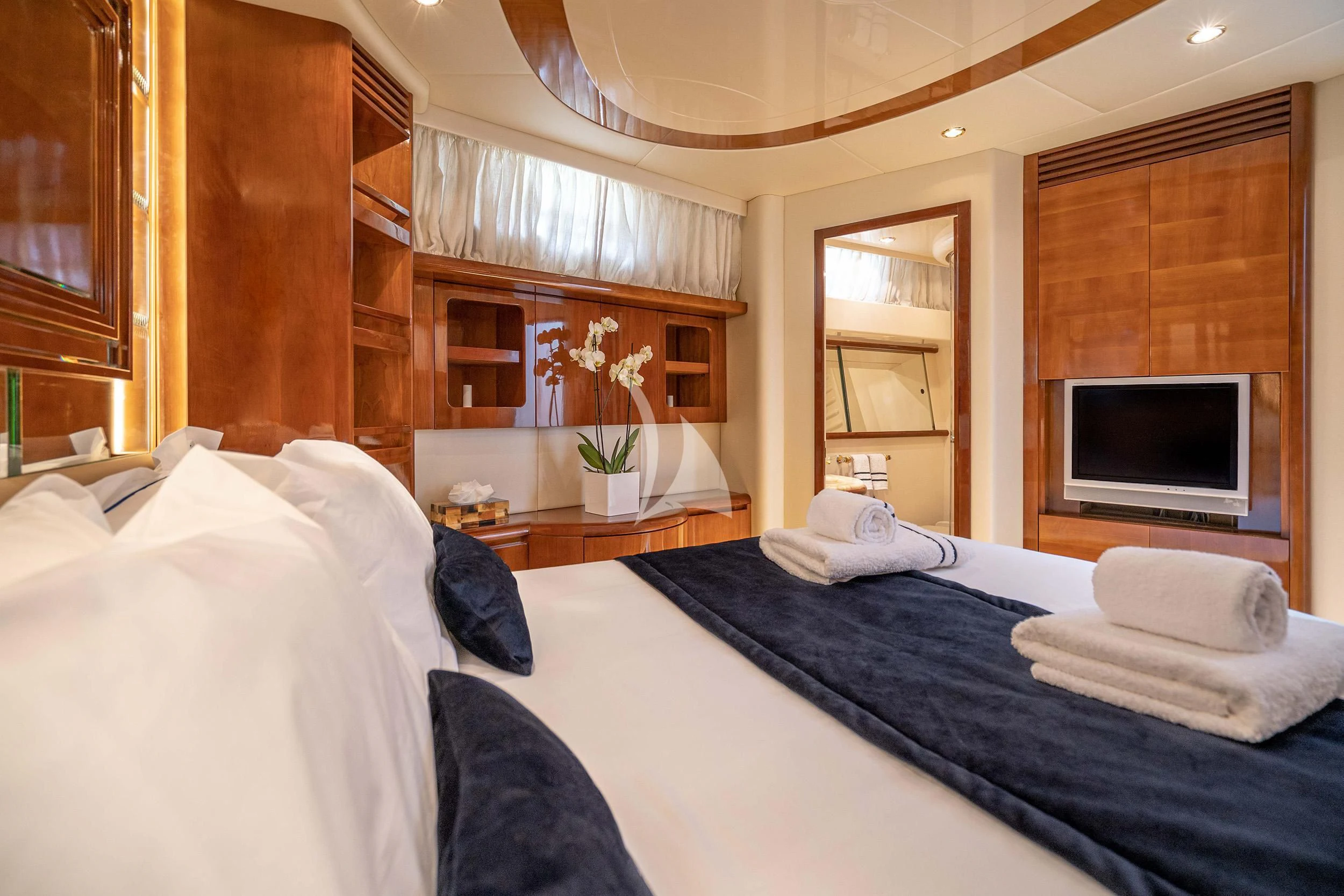 a bedroom with a bed and a tv aboard ESTIA ZEUS Yacht for Charter