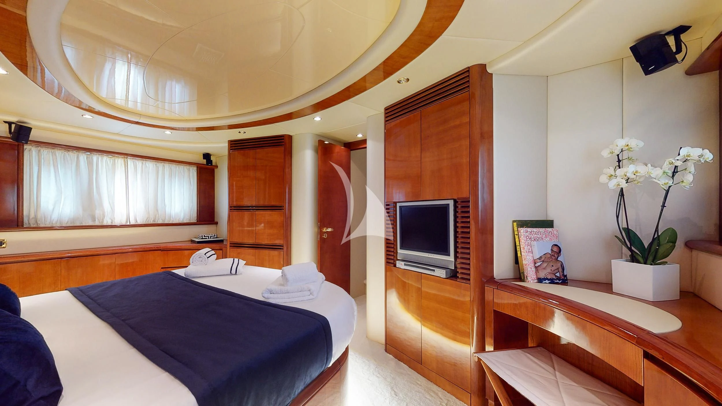 a bedroom with a bed and a television aboard ESTIA ZEUS Yacht for Charter