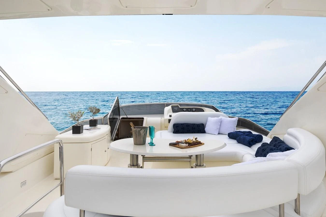 a room with a bed and a table with food on it aboard ESTIA ZEUS Yacht for Charter