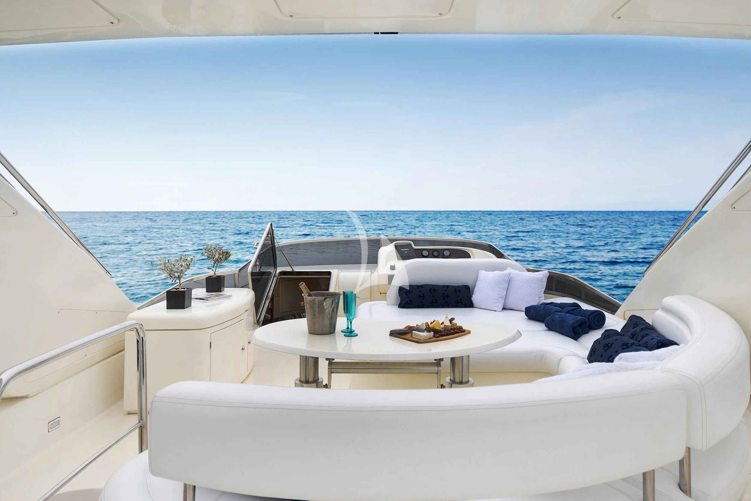 a room with a bed and a table with food on it aboard ESTIA ZEUS Yacht for Charter