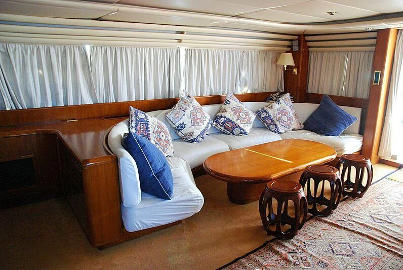 a living room with a couch and a table aboard NINETY TWO Yacht for Sale