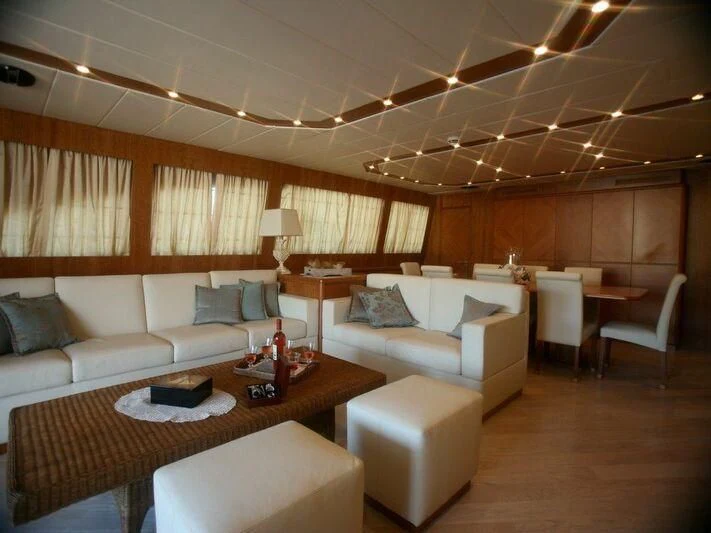 a living room with a couch and a table aboard STRIA 3 Yacht for Sale