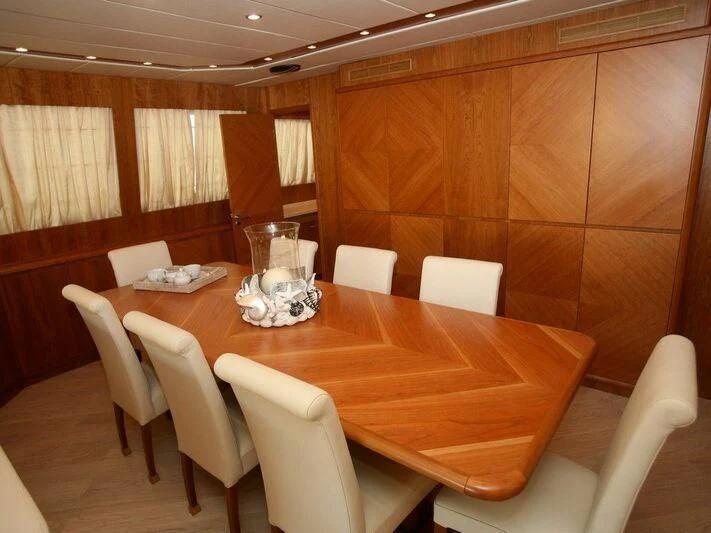 a table with chairs around it aboard STRIA 3 Yacht for Sale
