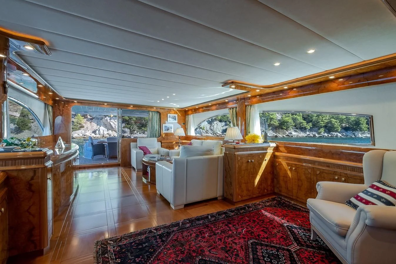 a large living room with a red rug aboard LADY ADELHEID Yacht for Sale