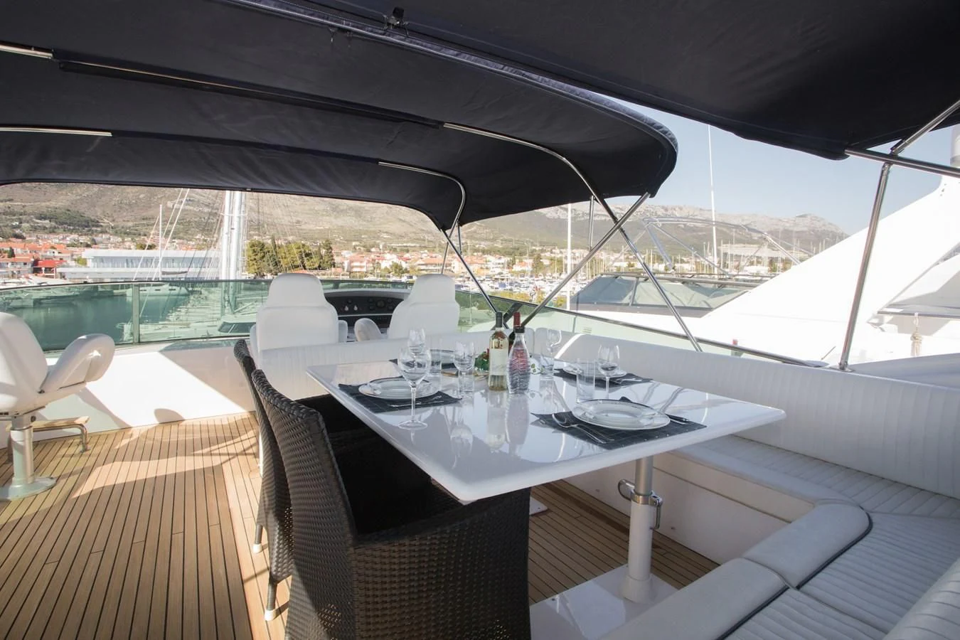 a table with glasses and a view of a city aboard LADY ADELHEID Yacht for Sale