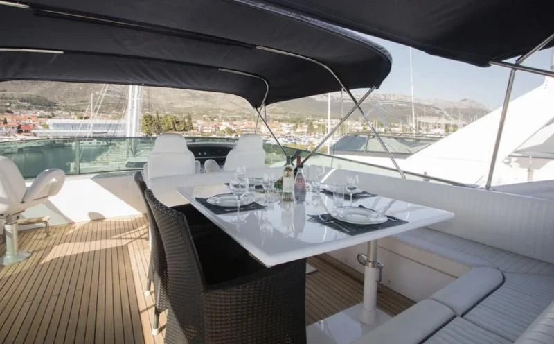 a table with plates and glasses on it aboard LADY ADELHEID Yacht for Sale