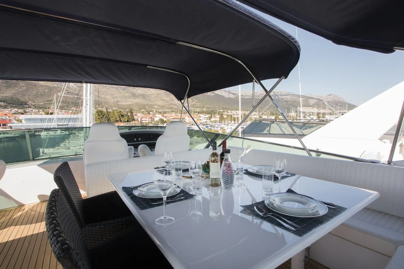 a table with plates and glasses on it aboard LADY ADELHEID Yacht for Sale