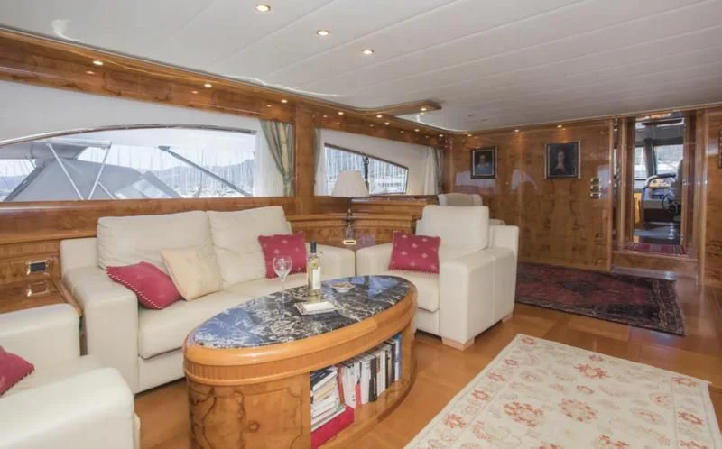 a living room with a couch and a table aboard LADY ADELHEID Yacht for Sale