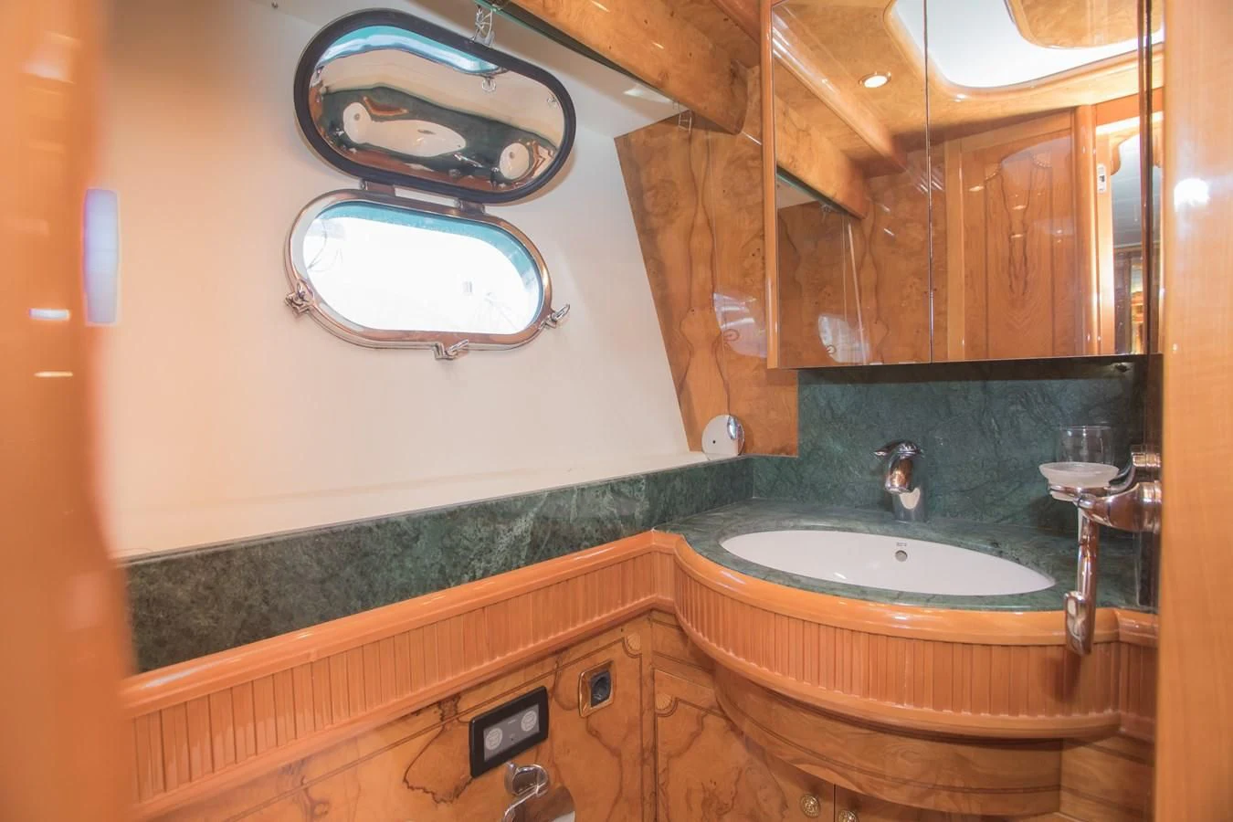 a bathroom with a sink and a mirror aboard LADY ADELHEID Yacht for Sale