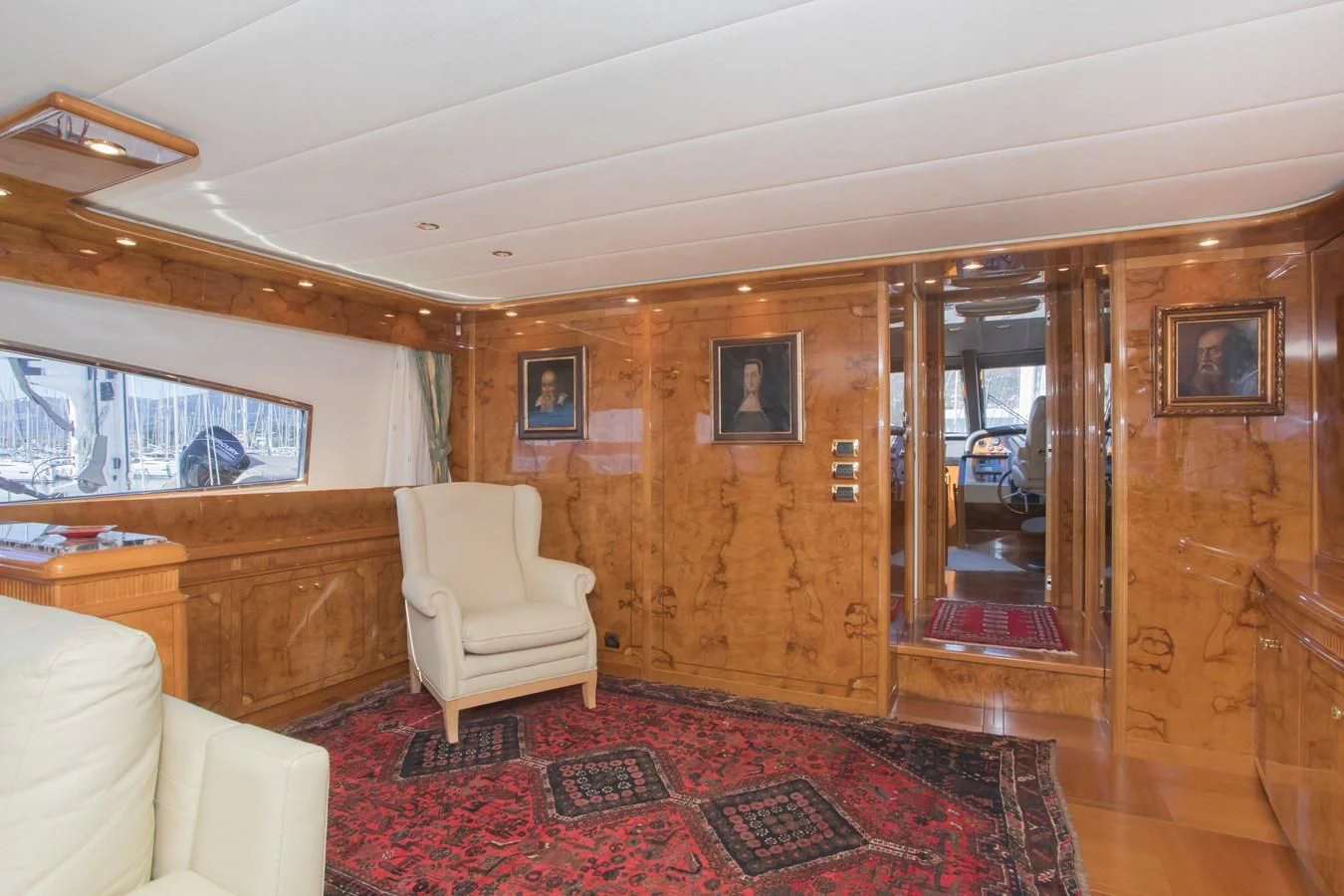a room with a red rug and a wood wall aboard LADY ADELHEID Yacht for Sale