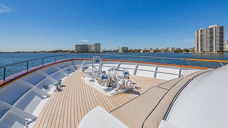 a deck with a large ship on it and a city in the background aboard CASUAL WATER Yacht for Sale