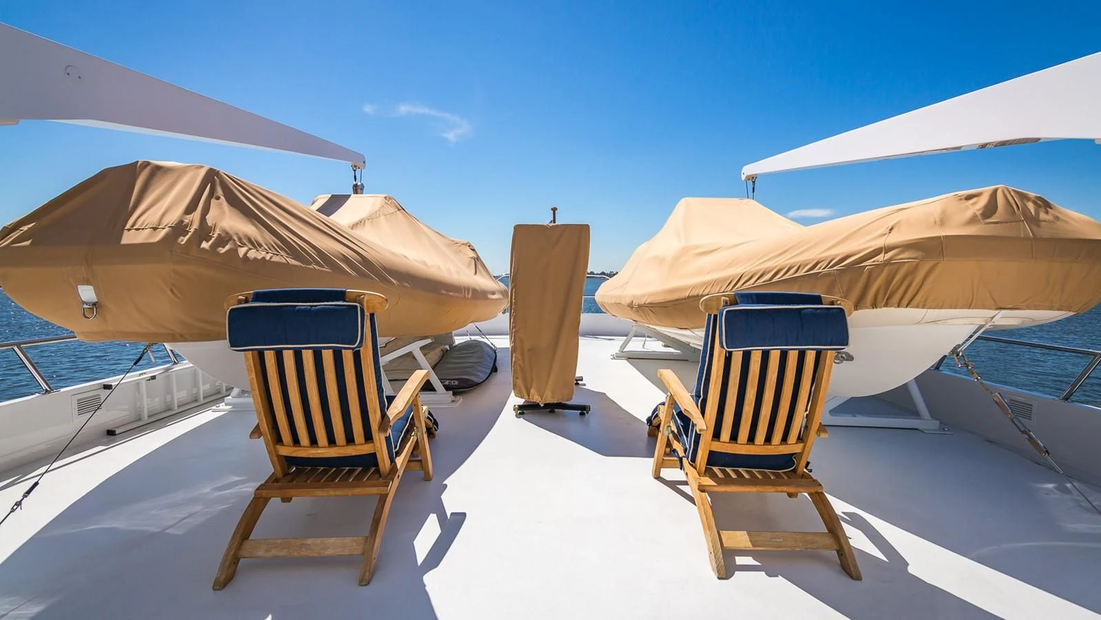 chairs and umbrellas on a beach aboard CASUAL WATER Yacht for Sale