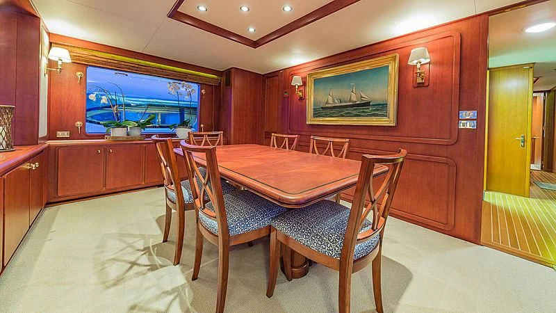 a room with a table and chairs aboard CASUAL WATER Yacht for Sale