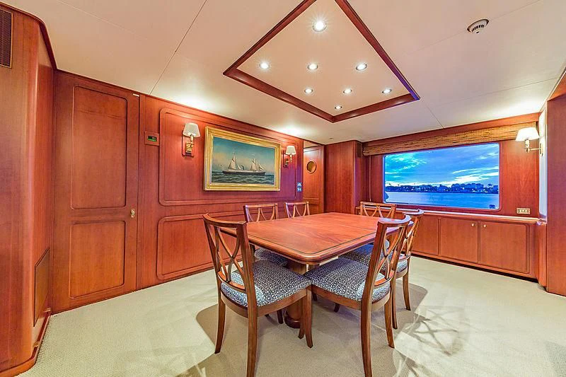 a room with a table and chairs aboard CASUAL WATER Yacht for Sale