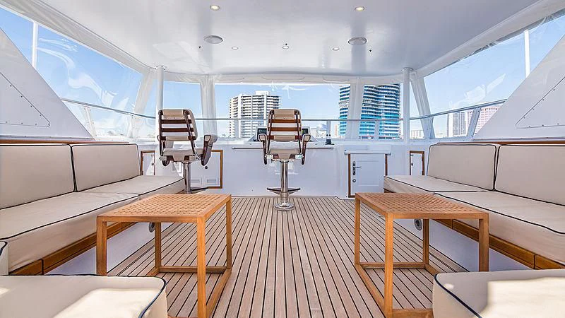 a room with a wood floor and a chair in it aboard CASUAL WATER Yacht for Sale