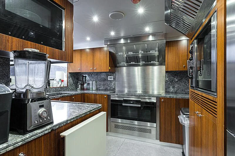 a kitchen with stainless steel appliances aboard BOMBAY Yacht for Sale