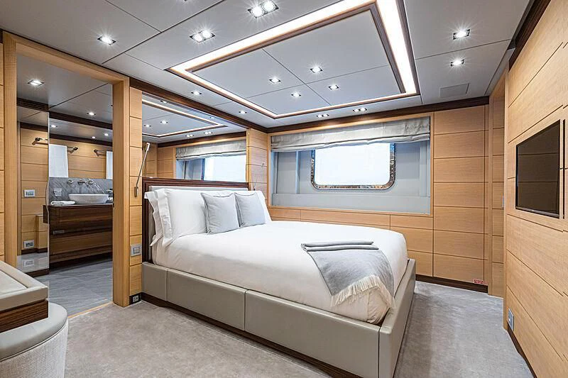 a room with a bed and a window aboard BOMBAY Yacht for Sale