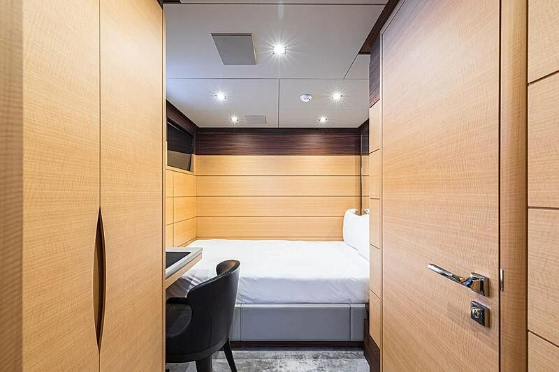 a room with a bed and a desk aboard BOMBAY Yacht for Sale