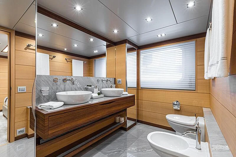 a bathroom with sinks and mirrors aboard BOMBAY Yacht for Sale