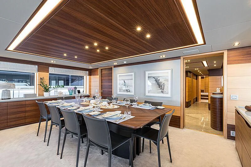 a large dining room with a table and chairs aboard BOMBAY Yacht for Sale