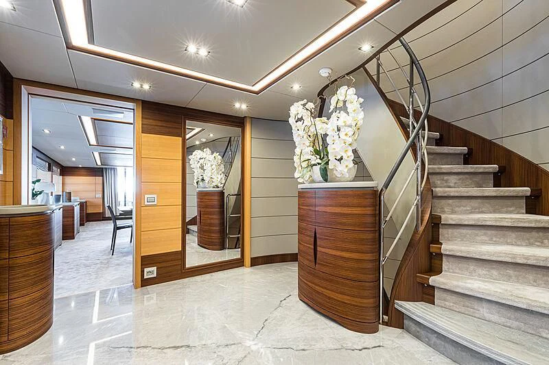 a large room with a staircase and a staircase aboard BOMBAY Yacht for Sale