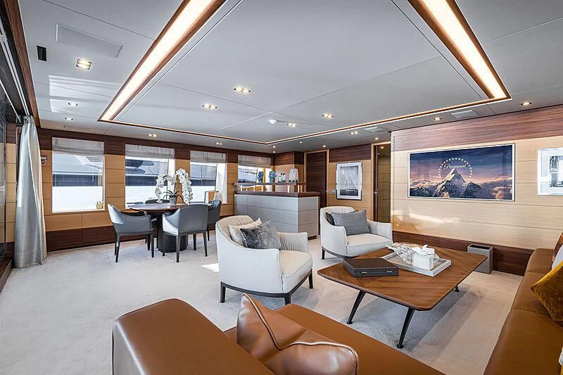 a room with a table chairs and a tv aboard BOMBAY Yacht for Sale