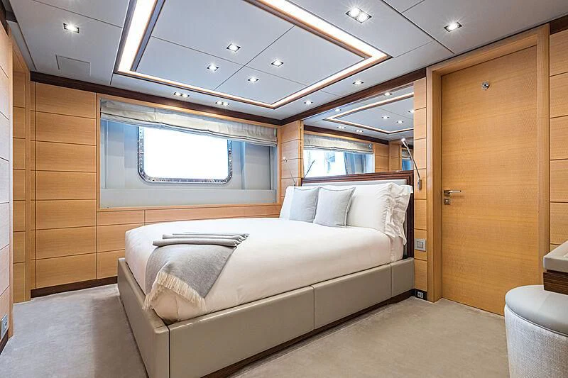 a room with a bed and a window aboard BOMBAY Yacht for Sale