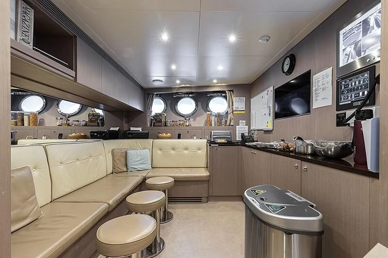 a room with a couch and a television on the wall aboard BOMBAY Yacht for Sale