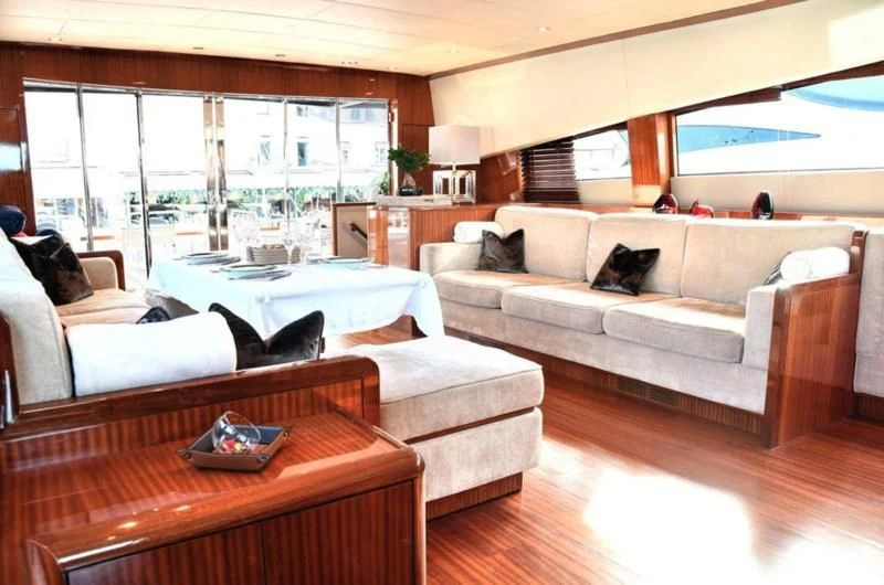 a living room with a couch and a table aboard DARK KNIGHT Yacht for Sale