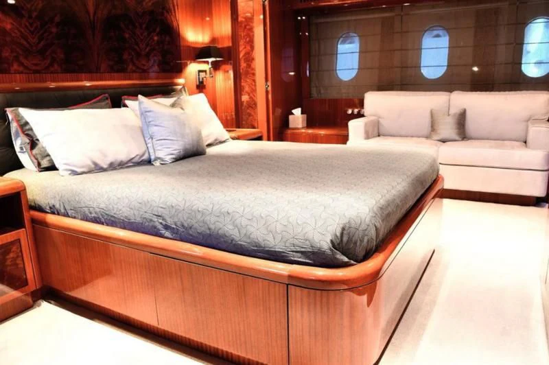 a bed with a white bed aboard DARK KNIGHT Yacht for Sale